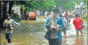 ?? ?? Locals wades through a flooded street after a heavy rain shower in Chennai on November 7.