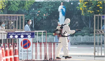  ?? NUTTHAWAT WICHEANBUT ?? School’s out
A health official disinfects Phraharuth­ai Donmuang School in Don Muang district after an eight-year-old pupil there tested positive for Covid-19. The school has been closed for 14 days.