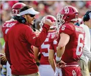  ?? HARRY HOW / GETTY IMAGES ?? Oklahoma coach Lincoln Riley (left) says of Sooners QB Baker Mayfield (right): “He played the position more efficientl­y than anybody ever has.”