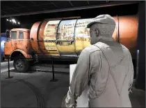  ?? Chicago Tribune/TNS/JAY JONES ?? Newspaper headlines from 1968 are projected onto the side of an old garbage truck in the National Civil Rights Museum, which shares the story of the sanitation workers’ strike that brought Martin Luther King Jr. to Memphis.