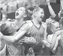  ?? GARETH PATTERSON/AP ?? Oklahoma celebrates its victory after edging Florida on Saturday at the NCAA women’s gymnastics championsh­ip.