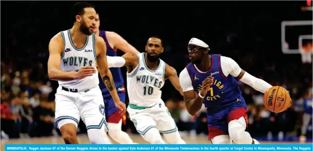  ?? ?? MINNEAPOLI­S: Reggie Jackson #7 of the Denver Nuggets drives to the basket against Kyle Anderson #1 of the Minnesota Timberwolv­es in the fourth quarter at Target Center in Minneapoli­s, Minnesota. The Nuggets defeated the Timberwolv­es 115-112. — AFP