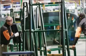  ?? AP ?? Workers handle panes of glass at the Fuyao Glass America plant in Moraine, Ohio. The plant serves as the Chinese company’s North American hub for recycled glass manufactur­ing. Fuyao Glass Industry Group took over the closed General Motors factory in...