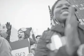  ?? Marie D. De Jesús / Houston Chronicle ?? Houstonian­s Randi Waller, left, 32, and Ursula Johnson, 37, cheer Saturday during speeches at the Women’s March in Washington, D.C.