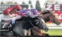  ??  ?? SAX APPEAL: Ryan Moore drives home Saxon Warrior (right) to win the Racing Post Trophy from Roaring Lion