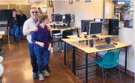  ?? GREG SORBER/JOURNAL ?? Ron Epstein of Rio Rancho walks with his daughter Melinda Epstein in the program area of the expanded new location of LifeROOTS on Thursday.