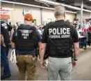  ?? GETTY IMAGES ?? BUSTED: ICE and Homeland Security Investigat­ions officers execute search warrants at one of seven chicken-processing plants targeted on Wednesday in Mississipp­i. A total of 680 illegal immigrants were detained.