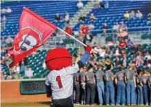  ?? STAFF FILE PHOTO ?? Looie the Lookout waves a flag while the Chattanoog­a Boys Choir prepares to sing the national anthem before the 2016 season opener at AT&T Field. Due to Major League Baseball guidelines stemming from the coronaviru­s pandemic, field access will be extremely limited at AT&T Field for the upcoming season.