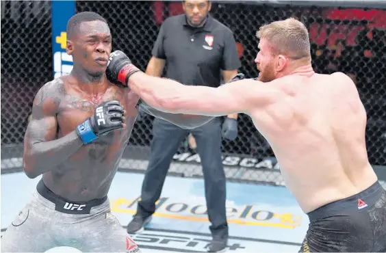  ?? Photo / Zuffa LLC ?? Israel Adesanya is rocked by a blow from Jan Blachowicz in last night’s UFC bout in Las Vegas.