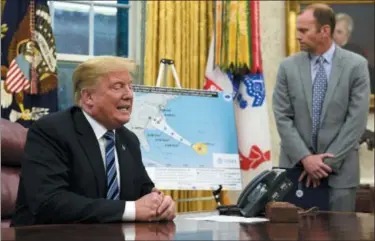  ?? SUSAN WALSH — THE ASSOCIATED PRESS ?? President Donald Trump, left, talks about Hurricane Florence during a briefing in the Oval Office of the White House in Washington as FEMA Administra­tor Brock Long listens at right.