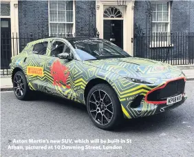 ??  ?? &gt; Aston Martin’s new SUV, which will be built in St Athan, pictured at 10 Downing Street, London