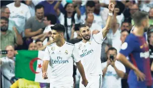  ?? AP ?? Real Madrid’s Karim Benzema (second left) celebrates after scoring his side’s second goal against Barcelona during the Spanish Super Cup second leg match at the Santiago Bernabeu stadium in Madrid yesterday.