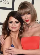  ?? JASON MERRITT/GETTY IMAGES FOR NARAS ?? Above, Selena Gomez and Taylor Swift cozy up on the red carpet. Right, Justin Bieber strikes a pose with his brother Jaxon. Bieber won with Skrillex and Diplo for best dance recording for "Where Are U Now.”