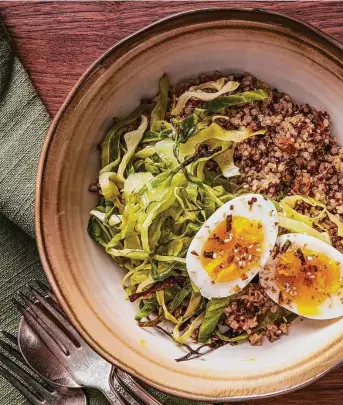  ?? Rey Lopez/for the Washington Post ?? Making a big batch of roasted cabbage ahead of time makes it easy to throw together some quick meals with minimal effort, like Roasted Cabbage Bowls With Quinoa and Soft-Boiled Eggs.