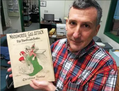  ?? PAUL POST — PPOST@DIGITALFIR­STMEDIA.COM ?? New York State Military Museum Librarian-Archivist Jim Gandy shows a copy of the 27th Division newspaper, “Gas Attack,” which soldiers read at Camp Wadworth near Spartanbur­g, S.C.