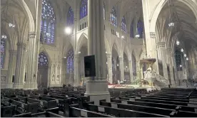  ?? SETH WENIG / AP ?? Cardinal Timothy Dolan, right, delivers his homily over mostly empty pews as he leads an Easter Mass at St. Patrick's Cathedral in New York on April 12.