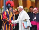  ?? Alessandro Di Meo/ANSA via AP ?? Pope Francis shakes hands with a Swiss Guard as he leaves after the opening of the 15th Ordinary General Assembly of the Synod of Bishops, at the Vatican, Wednesday.