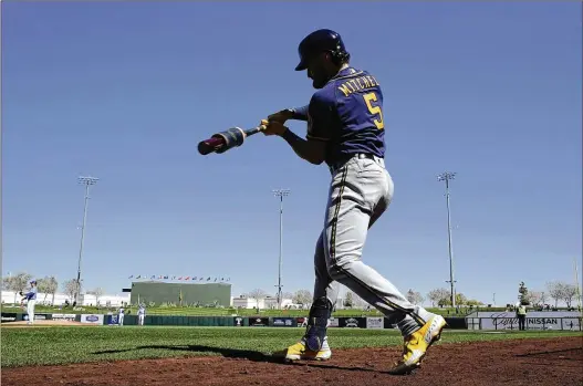  ?? CHARLIE RIEDEL/ASSOCIATED PRESS ?? The Milwaukee Brewers’ Garrett Mitchell warms up on deck Feb. 27 before a spring training game in Surprise, Arizona. Mitchell, a rookie center fielder, is the fastest man in the major leagues, able to get from home plate to first base in 4.01 seconds.