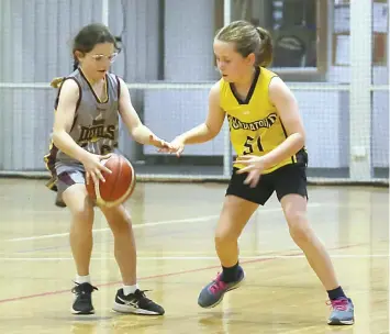  ?? ?? Devils player Madelin Williams attempts to dribble past Gladiators player Sophia Hoggard.