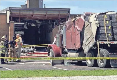  ?? THE BRENHAM BANNER-PRESS ?? Officials say a man stole an 18-wheeler Friday and deliberate­ly crashed it into the Texas Department of Public Safety office in Brenham.