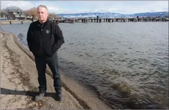  ?? GARY NYLANDER ?? Stacey Harding, parks and fleets supervisor for the City of West Kelowna, stands a the end of Aberdeen Park off West Bay Road, where the city hopes to rope off part of the water to keep swimmers safe from boaters using the private docks in the...