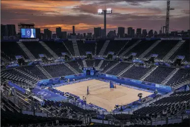  ?? PETROS GIANNAKOUR­IS — THE ASSOCIATED PRESS ?? The sun sets during a beach volleyball match July 26 in Tokyo.