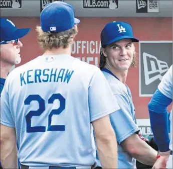  ?? Alex Brandon Associated Press ?? ZACK GREINKE, right, joins Dodgers teammate Clayton Kershaw and Mark McGwire, far left, in the dugout after completing eight scoreless innings on the mound against theWashing­ton Nationals.