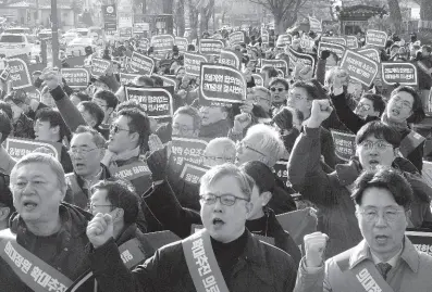  ?? AP ?? Doctors stage a rally against the government’s medical policy near the presidenti­al office in Seoul, South Korea, on Sunday, February 25.