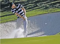  ?? JULIO CORTEZ/THE ASSOCIATED PRESS ?? Jordan Spieth hits from a sand trap on the 11th hole Thursday during the Presidents Cup foursomes at Liberty National Golf Club in Jersey City, N.J.