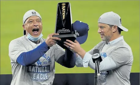  ?? AP ?? Los Angeles Dodgers manager Dave Roberts, left, and President of Baseball Operations Andrew Friedman celebrate after winning the NLCS on Sunday.