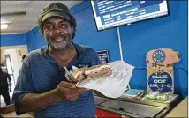  ?? COURTESY OF VISIT PENSACOLA ?? Owner J. Byron Long presents one of Blue Dot’s greasy, barbecuesa­uced burgers in Pensacola, Fla.