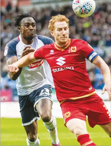  ??  ?? IN CONTROL: MK Dons captain Dean Lewington shields the ball from Bolton’s Joe Dodoo