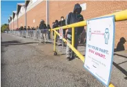  ?? FRANK GUNN / THE CANADIAN PRESS ?? Young people line up for COVID-19 vaccines at Downsview Arena in Toronto on Monday. There are signs of hope in Ontario and Quebec against the virus.