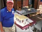  ??  ?? Southern Saratoga County Chamber of Commerce President Peter Bardunias displays a replica wooden canal boat that’s used to teach history lessons. Ballston Spa students used 21st century technology to create a remote-controlled rudder that steers the...