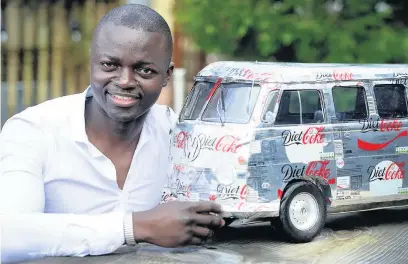  ??  ?? ●●Sinhote Co with the a scale model of a VW camper van he made using empty Coke cans and tins