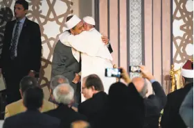  ?? L'Osservator­e Romano ?? Pope Francis hugs Sheikh Ahmed el-Tayeb at Cairo’s Al Azhar university. The pope is in Egypt to promote a united Christian-Muslim front against violence.