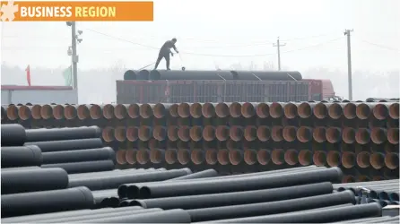  ?? — AFP ?? A worker packs pipelines onto a truck at a local plastic pipe factory in Donghegang village on the outskirts of Xiongxian county, China.
