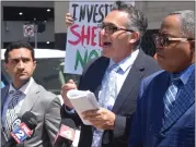  ?? MACOMB DAILY FILE PHOTO ?? Azzam Elder, center, speaks at a news conference in
July 2022in front of the federal courthouse in Detroit surrounded by by attorney Michael Chehab, left, and client Willie J. Rideout Jr., regarding Rideout’s lawsuit against Shelby Township, Macomb County and others for his arrest at a Shelby Township protest rally two years ago.