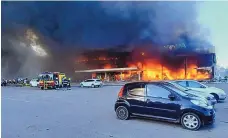  ?? UKRAINIAN STATE EMERGENCY SERVICE VIA AP ?? Firefighte­rs work to extinguish a fire at a shopping center burned after a Russian rocket attack in Kremenchuk, Ukraine, Monday.