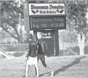  ??  ?? Students walk to class for the first day back at Marjory Stoneman Douglas High School on Aug. 15 in Parkland, Fla. WILFREDO LEE/AP
