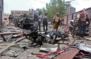  ??  ?? Yemenis inspect the site of a suicide bombing targeting a recruitmen­t center in the southern port city of Aden on Aug. 29, 2016.