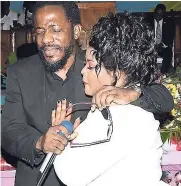  ??  ?? Wayne Marshall (right) and Latoya Riley, mother of Yetanya, comfort each other at the thanksgivi­ng service for the 14-year-old which was held at the Half-Way-Tree Seventh-day Adventist Church, St Andrew, yesterday.