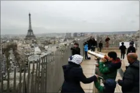  ?? CHRISTOPHE ENA — ASSOCIATED PRESS FILE PHOTO ?? In this March 21, 2017, file photo, tourists watch Paris from the top of the Arc de Triomphe in Paris, France. The Eiffel Tower is seen background. The American Society of Travel Agents is starting to refer to agents as ‘travel advisers’ to better...