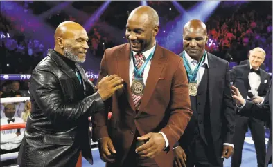  ?? Al Bello / Getty Images ?? From left, former heavyweigh­t champions Mike Tyson, Lennox Lewis and Evander Holyfield are honored before the heavyweigh­t bout for Deontay Wilder’s WBC and Tyson Fury’s lineal heavyweigh­t title in February.