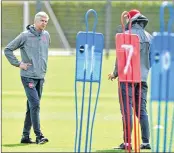  ??  ?? Arsenal's Arsene Wenger (C) attends a training session on the eve of their Europa League first leg semi-final match against Atletico Madrid at Arsenal's London Colney training ground on Wednesday.