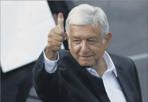  ??  ?? Presidenti­al candidate Andres Manuel Lopez Obrador shows his ink-stained thumb after casting his vote yesterday.