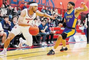  ?? STEPHEN LEITHWOOD BROCK UNIVERSITY ?? The Brock Badgers’ Jordan Tchuente drives the ball against Toronto Metropolit­an University. Tchuente is returning to the Canadian Elite Basketball League for a third summer with the Niagara River Lions.