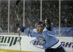  ?? DAVID DUPREY - THE ASSOCIATED PRESS ?? FILE - In this Jan. 1, 2008, file photo, Pittsburgh Penguins’ Sidney Crosby celebrates his game winning shootout goal against the Buffalo Sabres during the NHL Winter Classic outdoor hockey game at Ralph Wilson Stadium in Orchard Park, N.Y.