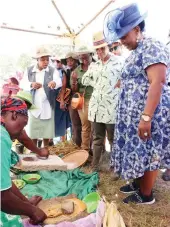  ?? - Picture: John Manzongo ?? First Lady Dr Auxillia Mnangagwa and her counterpar­t Mrs Neo Jane Masisi who is in the country to learn from her life-changing initiative­s, look at Agric4She beneficiar­ies grinding sorghum to make mealie meal and peanut butter during a visit at Mr and Mrs Chifokoyo’s homestead in Mashonalan­d East yesterday.
