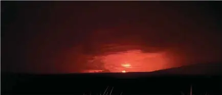  ?? (Reuters) ?? Mauna Loa’s summit region glows during an eruption as viewed by a geologist of the Hawaiian Volcano Observator­y in Hawaii yesterday.